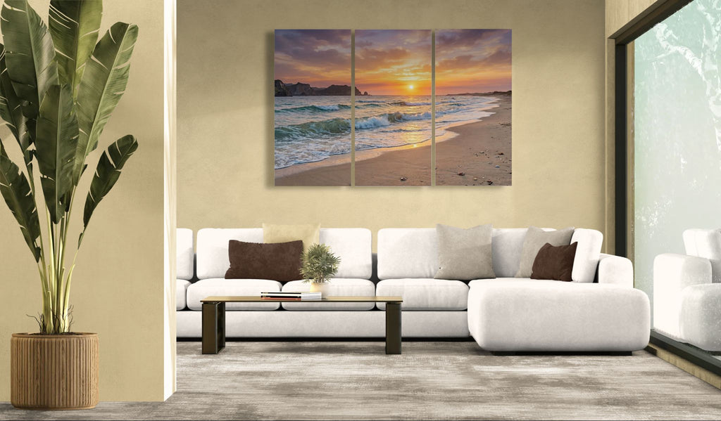 Living room with a white sofa, decorative pillows, and a large beach sunset painting on the wall.