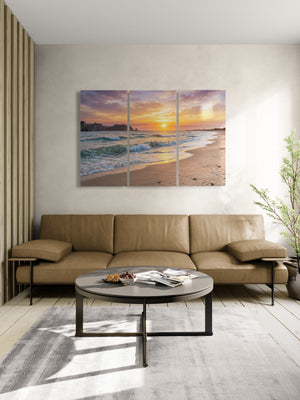 Modern living room with a sectional sofa, coffee table, and beach-themed wall art.