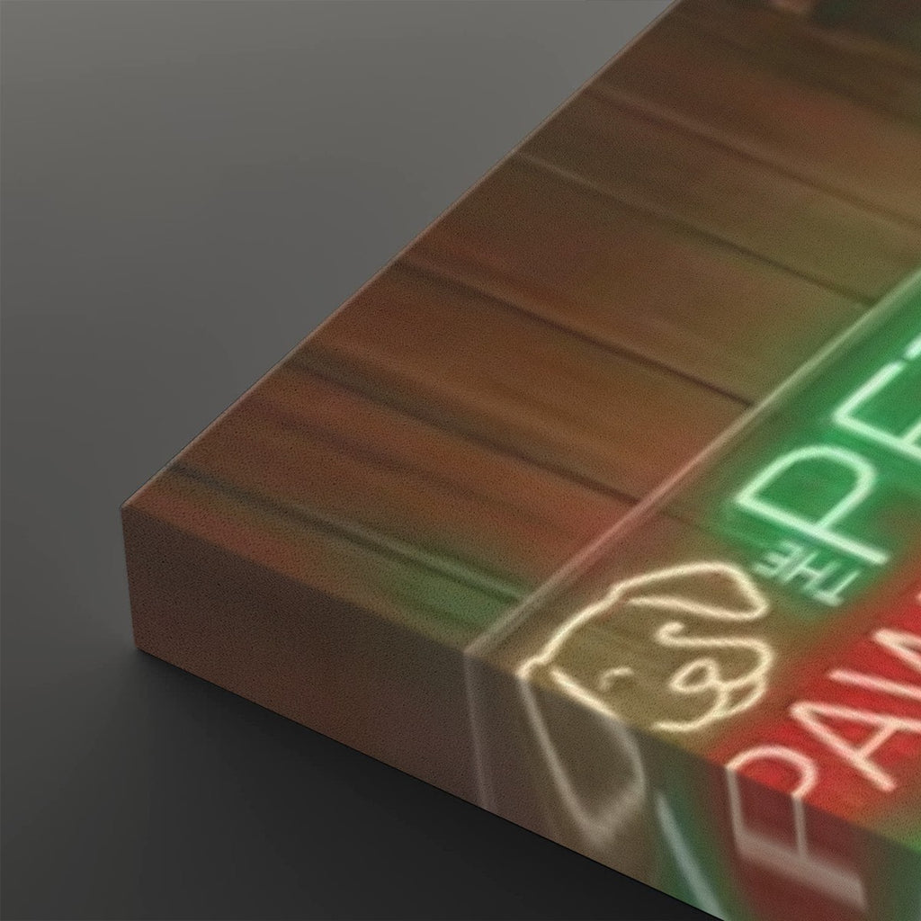A close-up angled view of a rectangular acrylic or glass wall art panel showing a neon-style painted design with green, red, and white lettering and a dog silhouette on a dark background.