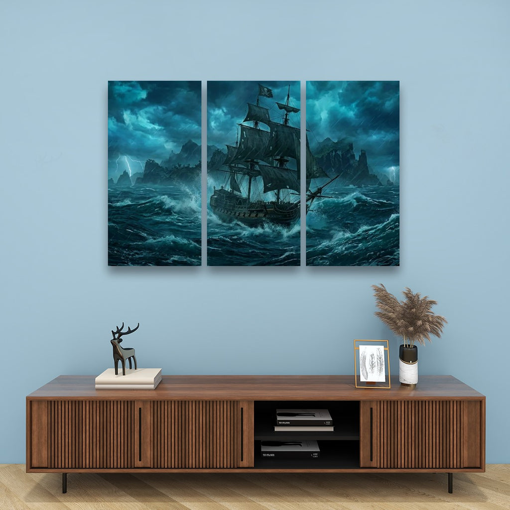 A three-panel canvas wall art set depicting a dark sailing ship battling stormy blue waves, displayed on a light blue wall above a wooden console table with decorative items.
