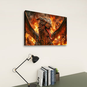 A rectangular wall art print showing a fiery dragon with wings spread, displayed above a desk with a black lamp and books against a light wall.