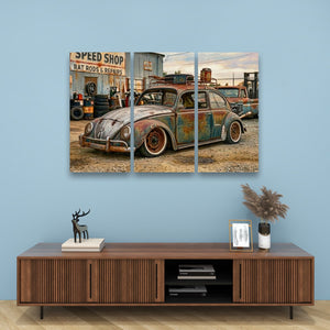 A three-panel canvas wall art print depicting a vintage rusted Beetle car in a speed shop, displayed on a light blue wall above a wooden console table with decorative items.