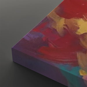 Abstract canvas wall art shown at an angle, featuring bold brushstrokes in red, purple, yellow, and teal on a dark gray background.