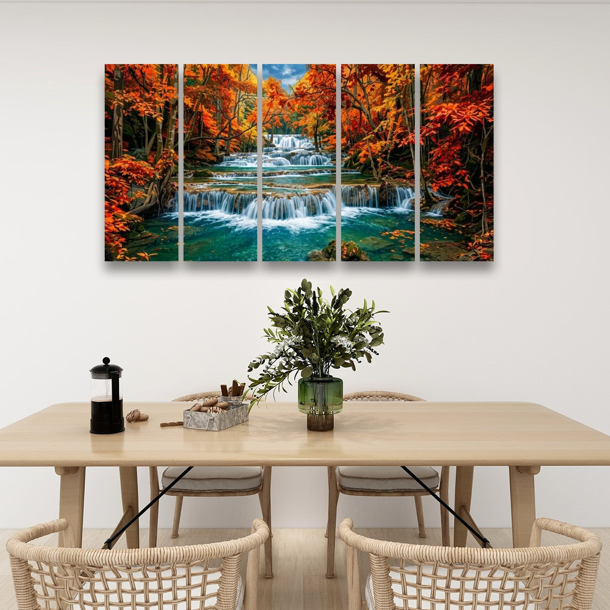 A five-panel canvas wall art set depicting a colorfulHuay Mae Khamin Falls, displayed on a white wall above a light wood dining table with woven chairs.