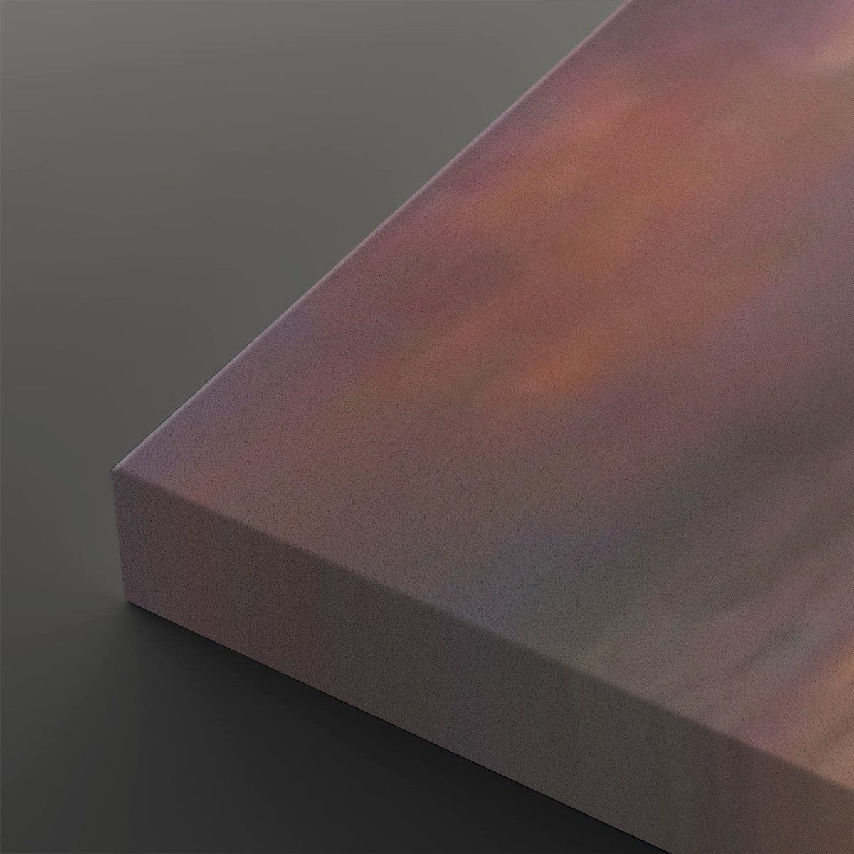 A close-up of a rectangular canvas or panel with a soft iridescent finish shifting between pink, purple, and warm peach tones, shown against a dark gray background.