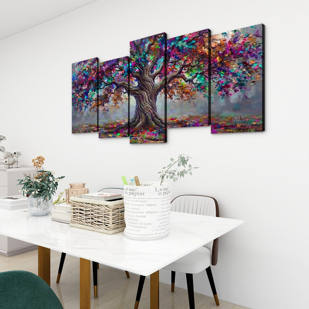 A 5-panel canvas wall art set depicting a colorful, textured tree with a brown trunk and vibrant multicolored foliage, displayed on a white wall above a dining table in a modern room setting.
