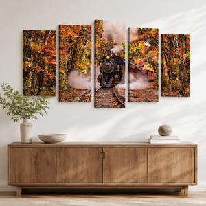 A five-panel canvas wall art set depicting a steam train traveling through an autumn forest, displayed on a white wall above a wooden sideboard with decorative vases and books.