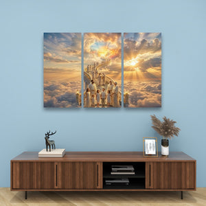 A three-panel canvas wall art print depicting a group of robed figures walking up a staircase toward a glowing sky, displayed above a wooden console table against a light blue wall.
