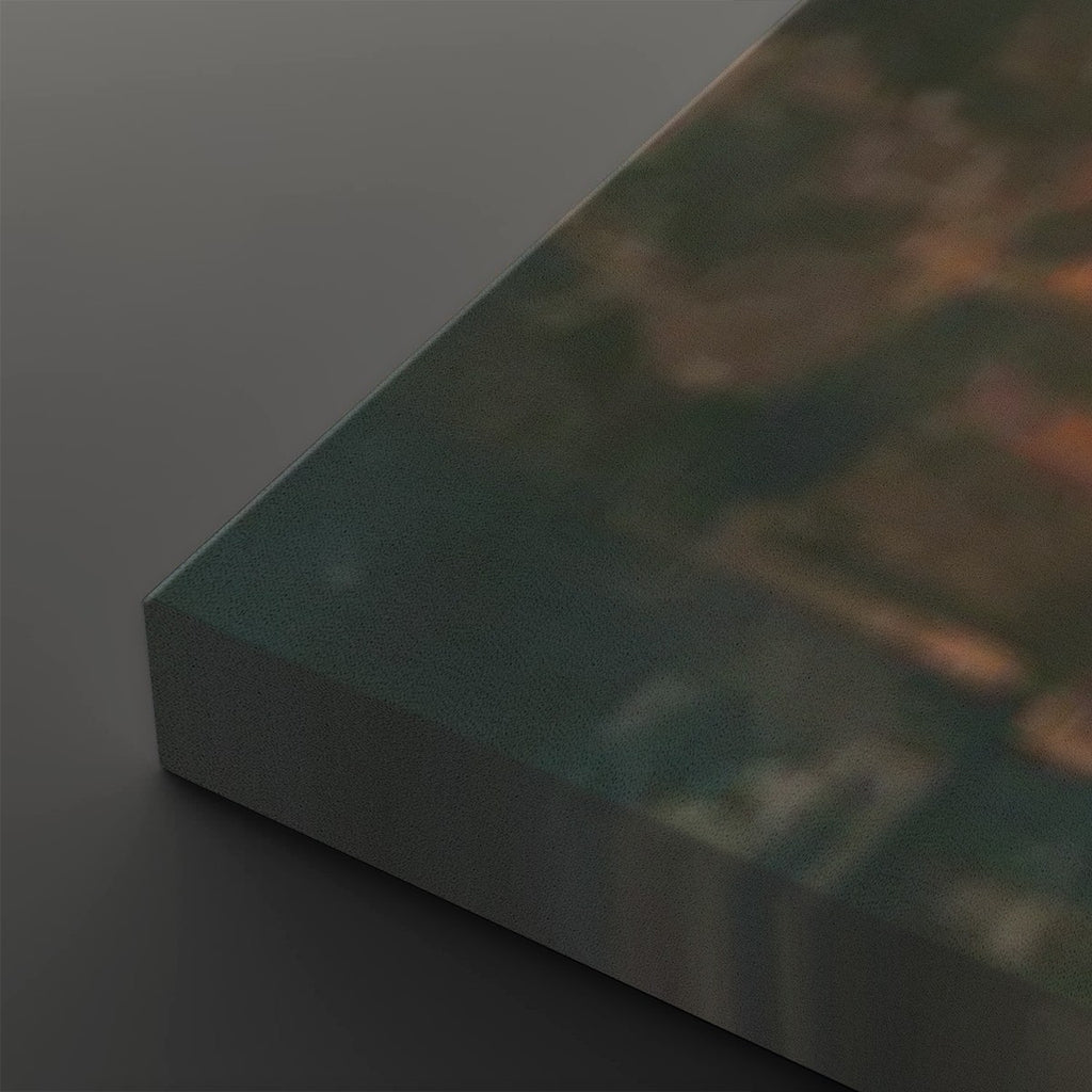 A close-up of a rectangular canvas or print showing an abstract landscape-like scene in muted teal, brown, and orange tones, photographed on a dark gray background.