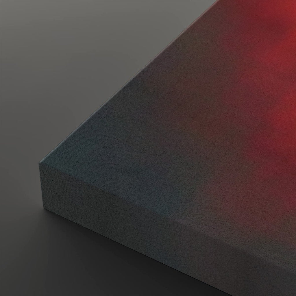 A close-up of a rectangular block or panel with a smooth gradient surface shifting from dark blue-gray on the left to deep red on the right, shown against a dark gray background.