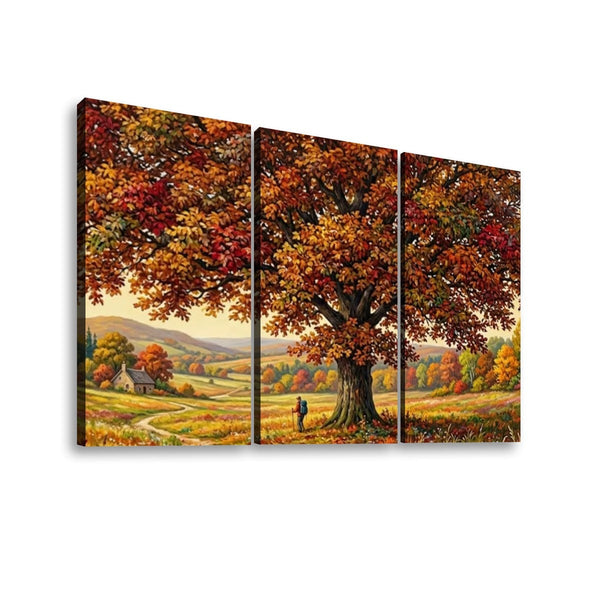 Three-panel canvas wall art showing an autumn landscape with a large tree in full fall foliage, rolling hills, and a small figure beneath the tree, displayed against a light gray background.