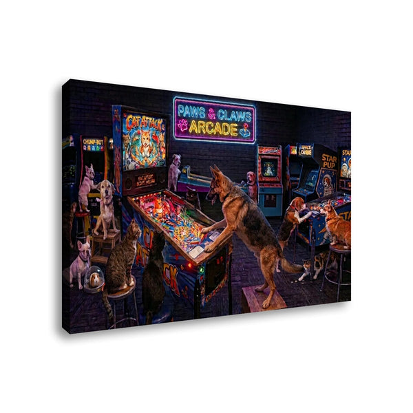 A rectangular canvas wall art print showing a neon-lit arcade room with several cats and dogs interacting with arcade machines, photographed against a plain white background.
