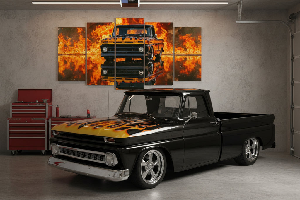 A 5-panel canvas wall art set depicting a black vintage  1966 Chevy C10 Fleetside pickup truck surrounded by bright orange flames and fiery reflections, displayed above a green sofa in a living room setting.