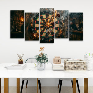 A 5-panel canvas wall art set depicting a burning dartboard, displayed in a modern living room setting above a white table with decorative items.