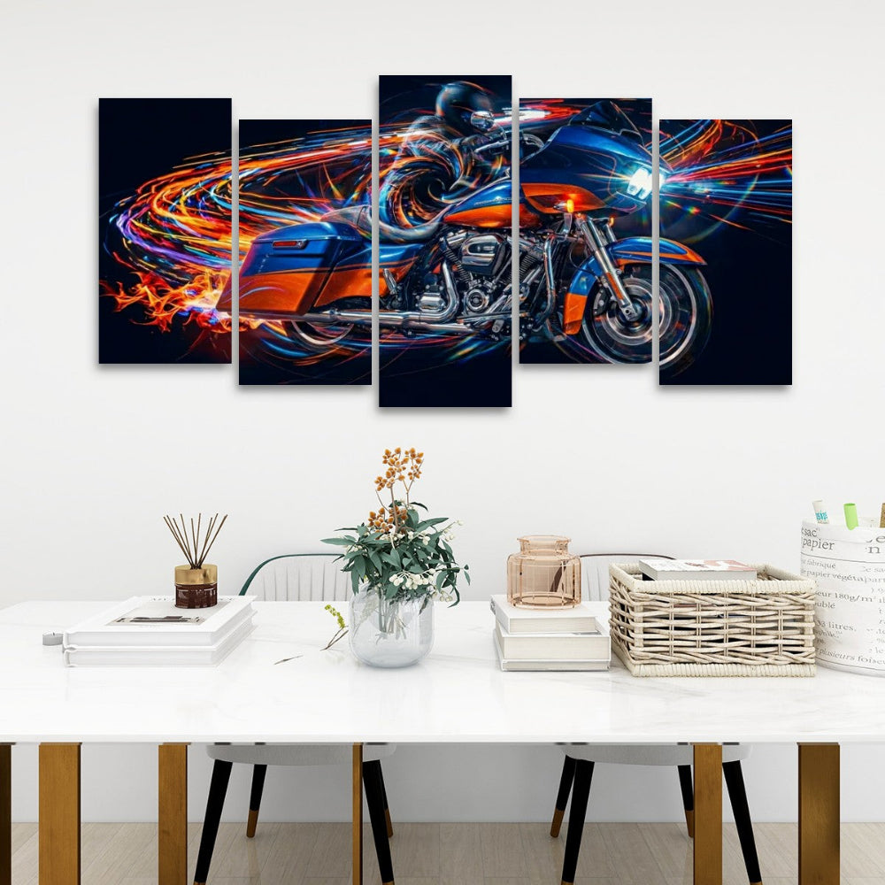 A 5-panel canvas wall art set depicting a Road Glide type motorcycle in motion with vibrant neon light trails, displayed on a white wall above a modern dining table with books, a vase, and a basket.