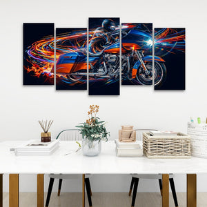 A 5-panel canvas wall art set depicting a Road Glide type motorcycle in motion with vibrant neon light trails, displayed on a white wall above a modern dining table with books, a vase, and a basket.