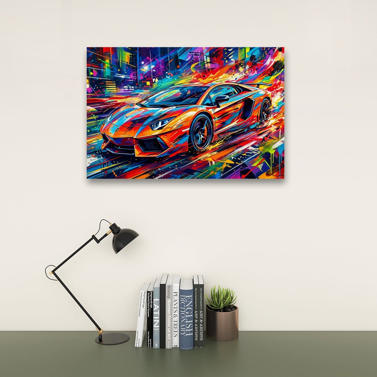 A colorful canvas wall art print depicting a vibrant sports car in a neon city scene, displayed on a beige wall above a desk with a black lamp, books, and a small potted succulent.