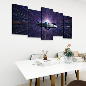 A five-panel canvas wall art set depicting a futuristic spacecraft in a purple and blue starburst space scene, displayed on a white wall above a dining table in a modern room setting.