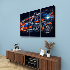 A three-panel canvas wall art set depicting a blue and orange Road Glide type motorcycle with glowing light trails, displayed on a light blue wall above a wooden console table with decorative items.