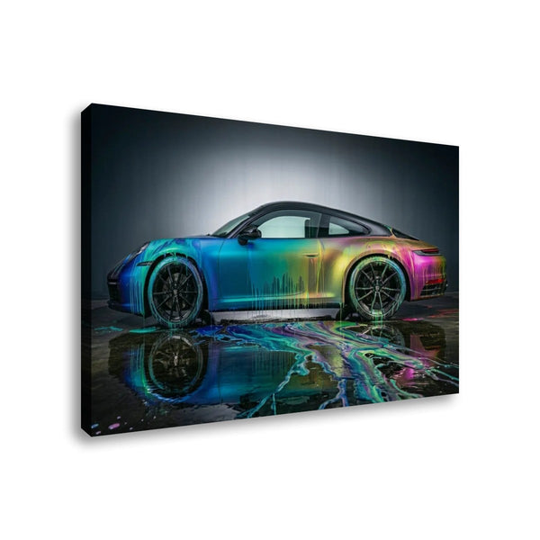 A rectangular wall art canvas showing a side view of a sports car with an iridescent rainbow finish, reflected on wet pavement against a dark studio background.