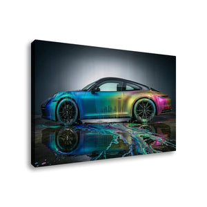 A rectangular wall art canvas showing a side view of a sports car with an iridescent rainbow finish, reflected on wet pavement against a dark studio background.
