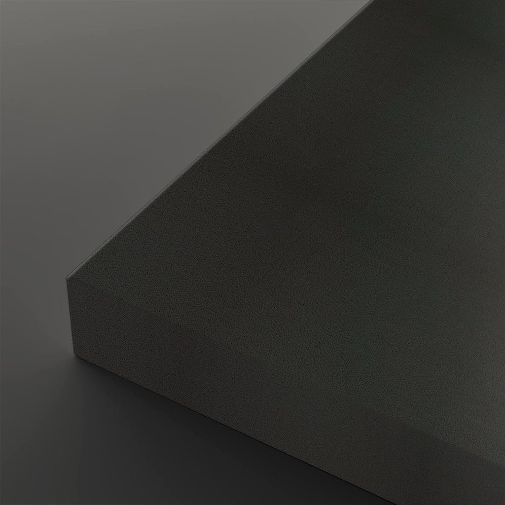 A close-up studio shot of a dark charcoal gray textured rectangular block showing its corner and matte surface against a matching dark gray background.