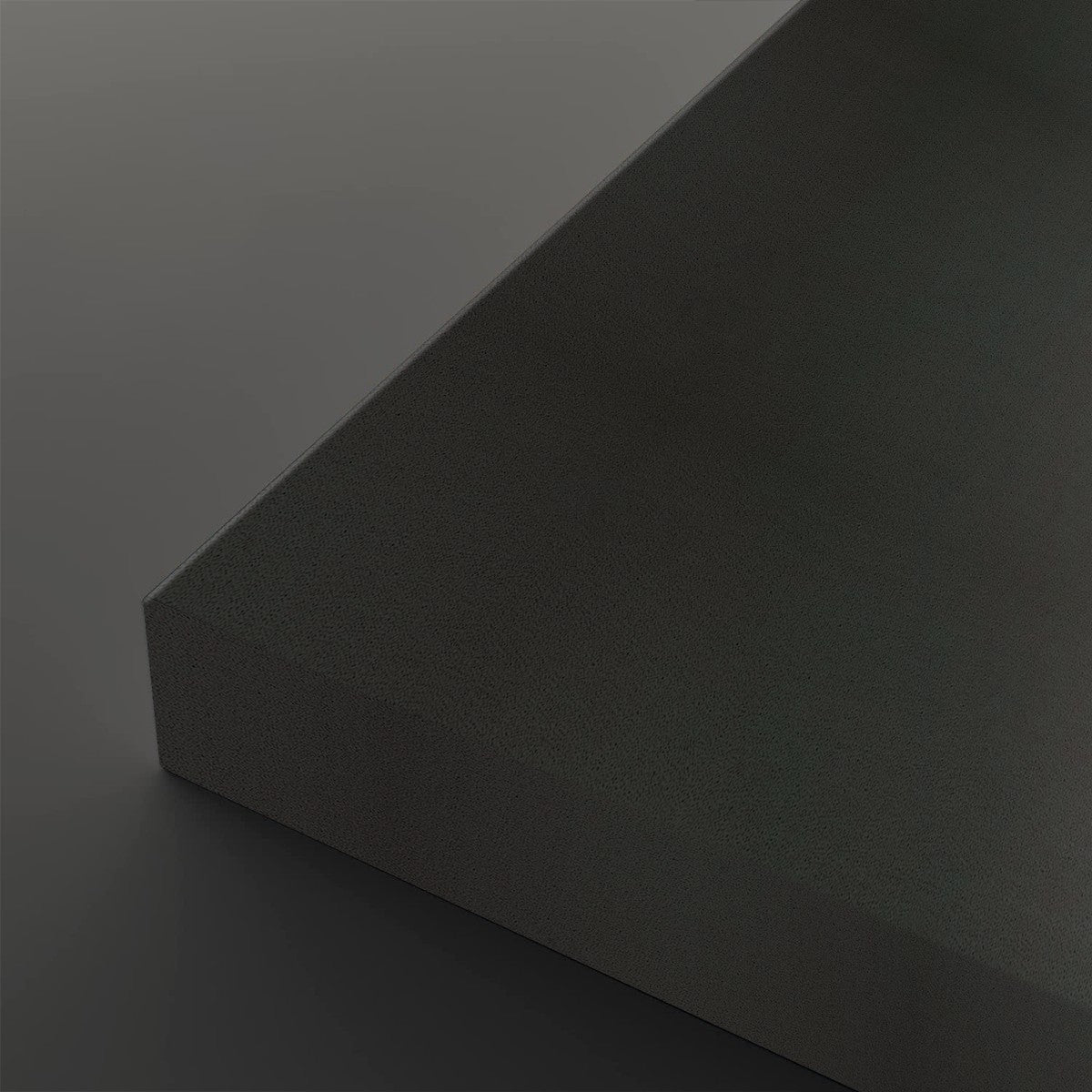 A close-up studio shot of a dark charcoal gray textured rectangular block showing its corner and matte surface against a matching dark gray background.