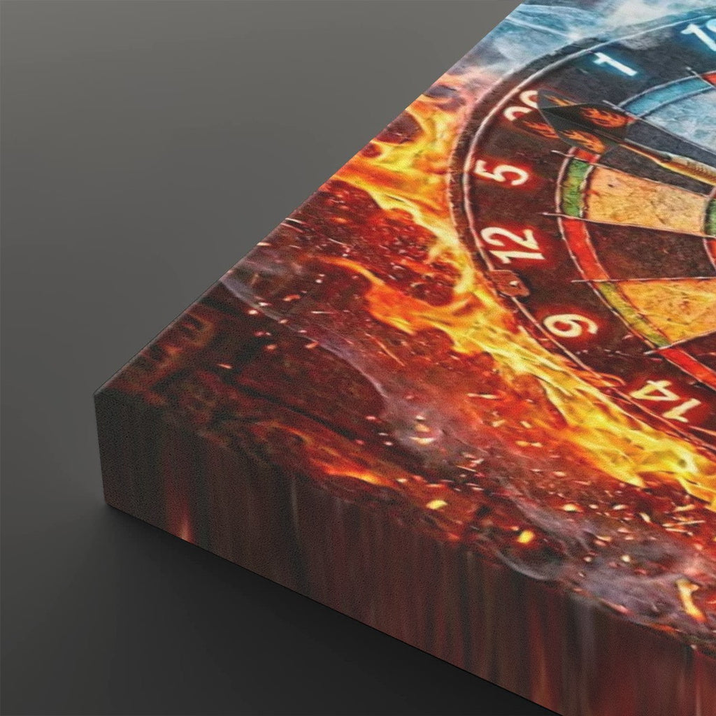 A close-up angled view of a rectangular canvas print showing a burning dartboard with flames, embers, and dark smoke against a dark gray background.
