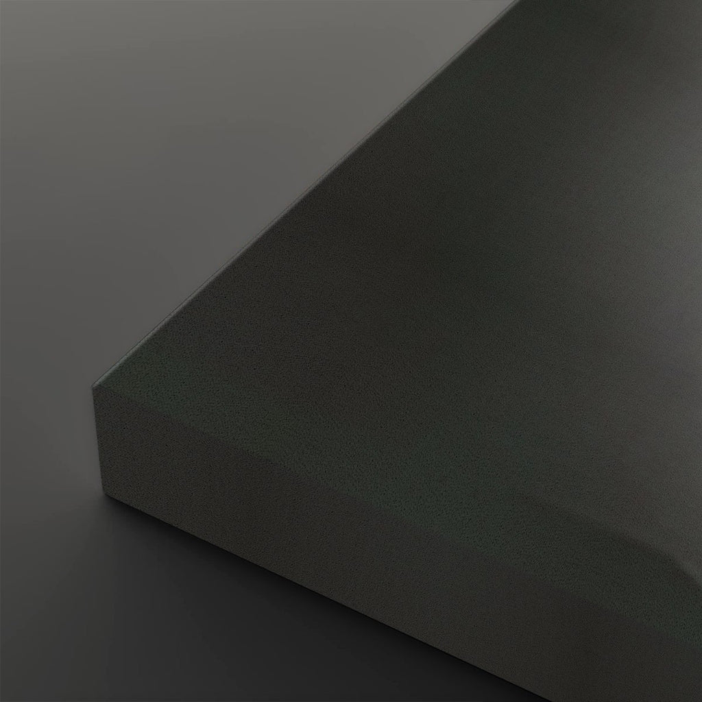 A close-up studio shot of a matte dark gray or charcoal-colored rectangular block corner against a matching dark gray background.