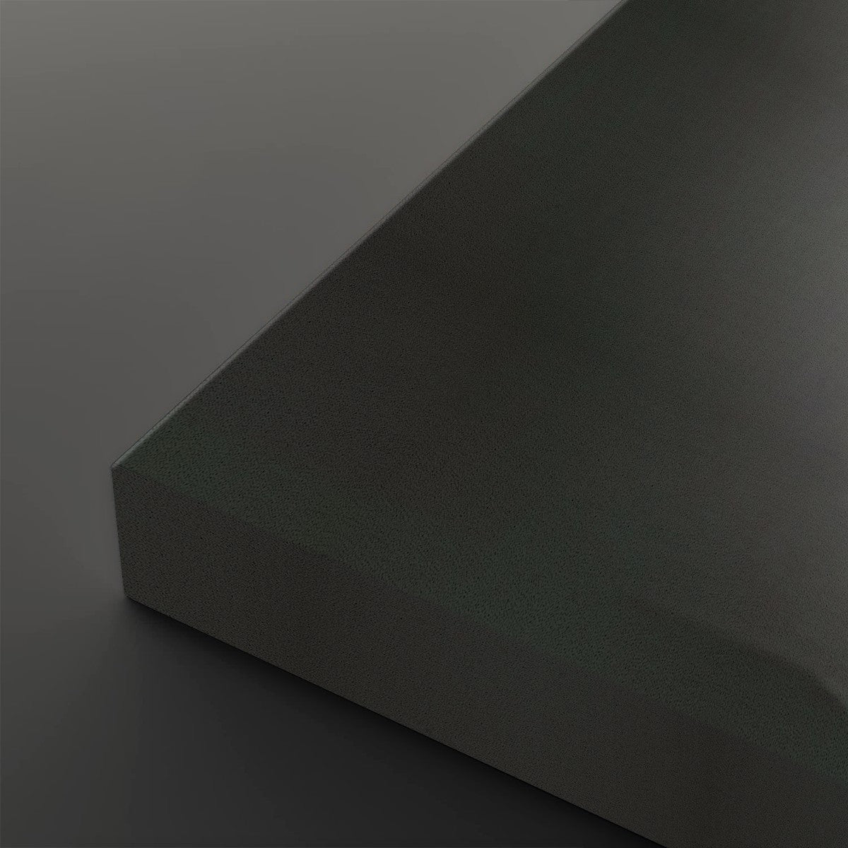 A close-up studio shot of a matte dark gray or charcoal-colored rectangular block corner against a matching dark gray background.
