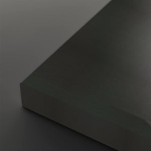 A close-up studio shot of a matte dark gray or charcoal-colored rectangular block corner against a matching dark gray background.
