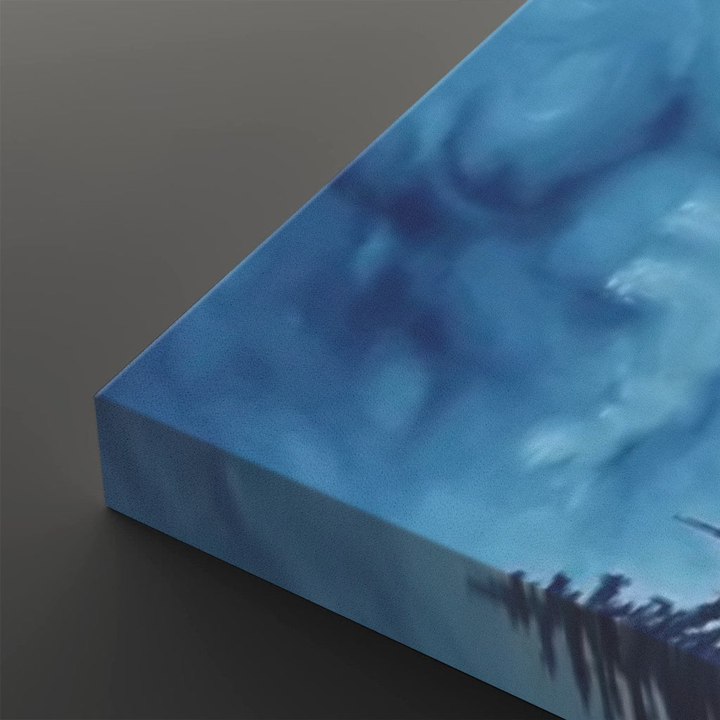 A close-up of a square canvas print showing its wrapped edge, featuring an abstract blue and white textured design with dark silhouetted shapes along the bottom, set against a dark gray background.