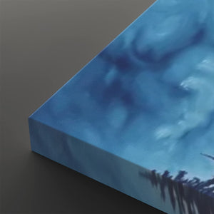 A close-up of a square canvas print showing its wrapped edge, featuring an abstract blue and white textured design with dark silhouetted shapes along the bottom, set against a dark gray background.