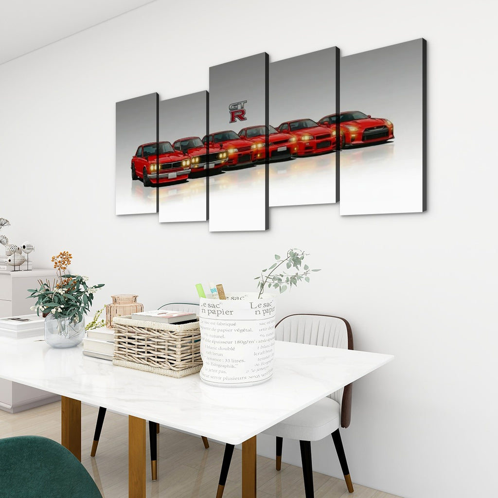 A five-panel canvas wall art set depicting a lineup of red sports cars, displayed on a white wall above a dining table in a modern room setting.