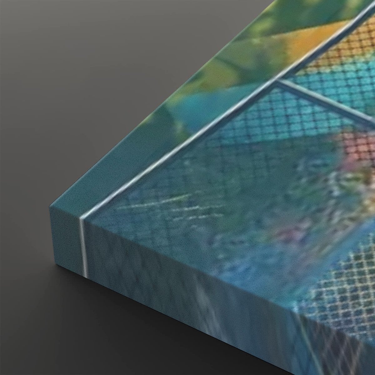 A close-up of a rectangular canvas or print showing an abstract blue-toned scene with a grid-like overlay and blurred multicolor areas, photographed on a dark gray background.