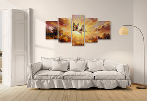 Five-panel wall art of a butterfly against a sunset sky above a white sofa.