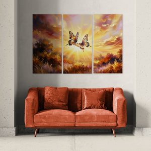 Triptych painting of butterflies over a red sofa against a gray wall.