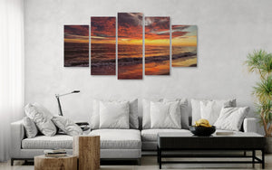 Living room with a white sofa and a large wall art piece depicting a sunset over water.