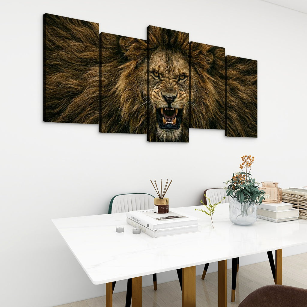 A five-panel canvas wall art set depicting a roaring lion in warm brown and black tones, displayed above a white dining table in a modern room setting.