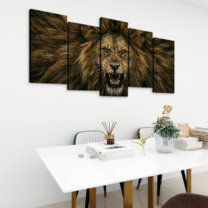 A five-panel canvas wall art set depicting a roaring lion in warm brown and black tones, displayed above a white dining table in a modern room setting.