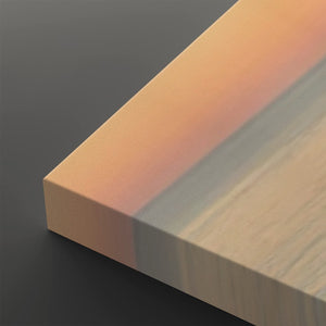 A close-up of a rectangular wood veneer or panel sample showing a warm peach-orange tone on one side and a light natural wood grain on the other, photographed on a dark gray background.