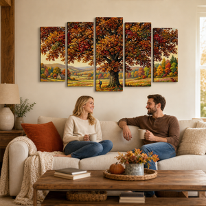 A five-panel canvas wall art set depicting a large autumn tree in a colorful forest, shown hanging above a living room sofa with a couple holding mugs.