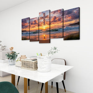 A five-panel canvas wall art set depicting a dramatic sunset over the ocean, displayed on a white wall above a dining table in a modern room setting.