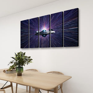 A four-panel canvas wall art set depicting a spaceship in a starburst space scene, displayed on a white wall above a wooden dining table with chairs and a plant.
