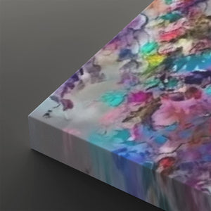 A close-up of a square canvas print showing its wrapped edge, featuring an abstract watercolor design with blended purple, blue, pink, teal, yellow, and white tones on a dark gray background.