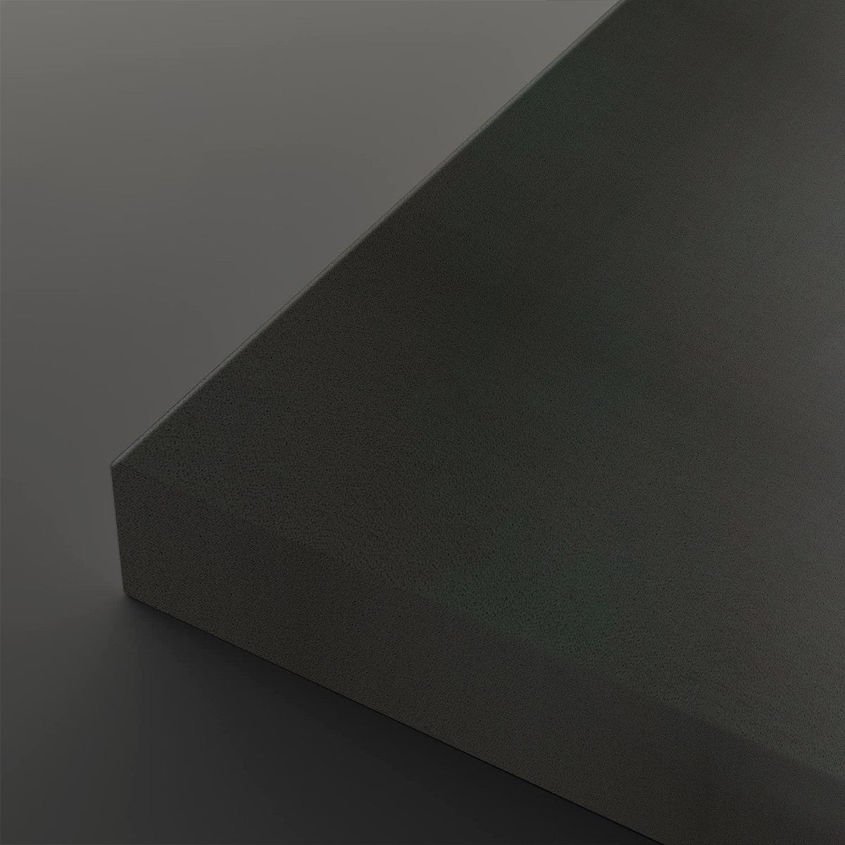 A close-up studio shot of a dark charcoal gray textured rectangular block showing its corner and matte surface against a matching gray background.