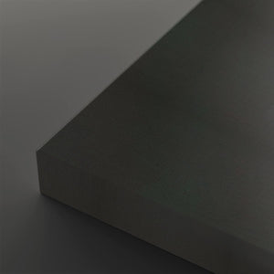 A close-up studio shot of a dark charcoal gray textured rectangular block showing its corner and matte surface against a matching gray background.