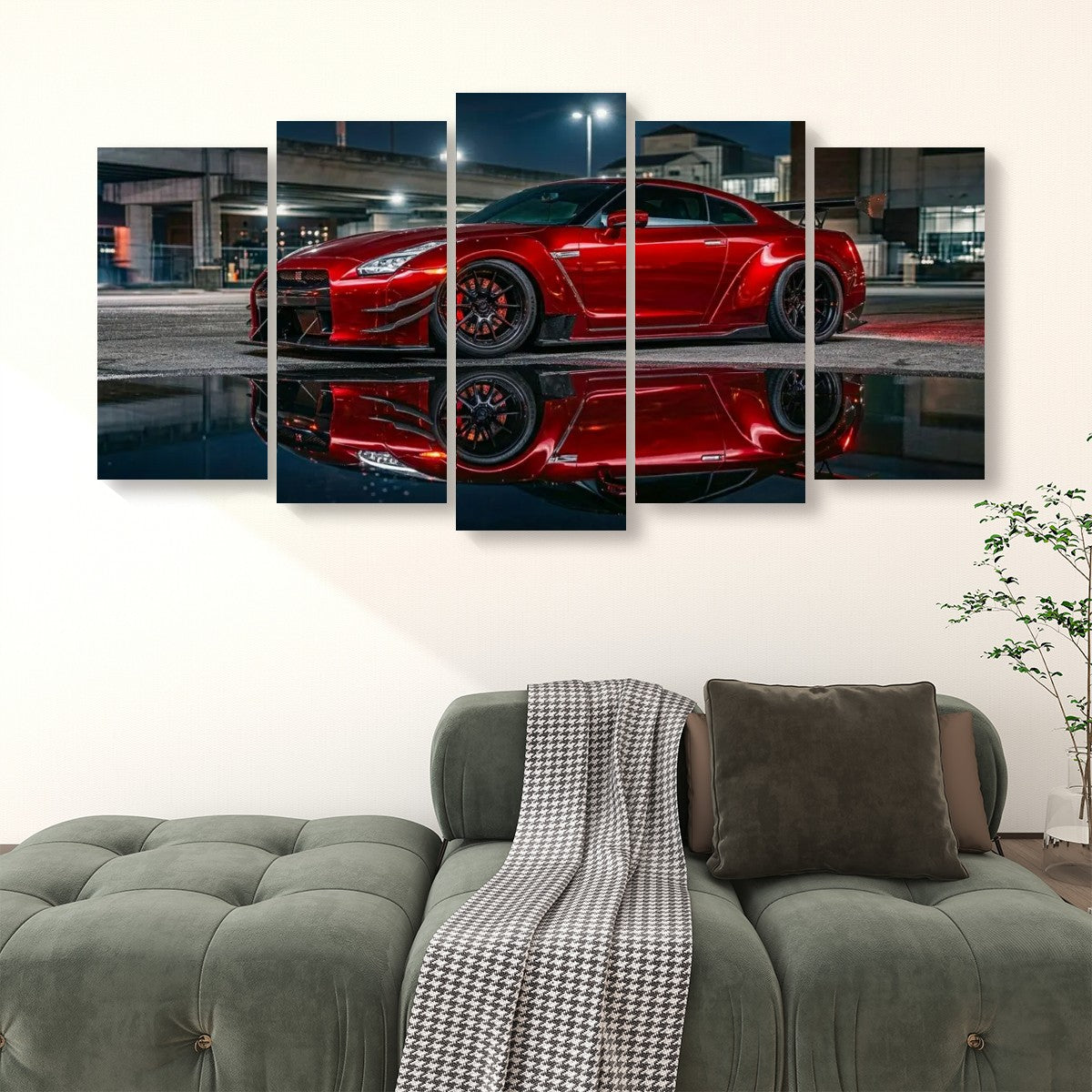 A 4-panel canvas wall art set depicting a red  Nissan GTR R35 sports car reflected in water at night, displayed on a wall above a green tufted sofa in a living room setting.