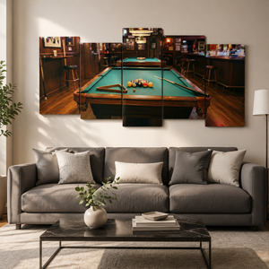 A multi-panel canvas wall art print depicting a pool table in a dimly lit bar, displayed above a modern gray fabric sofa in a styled living room setting.