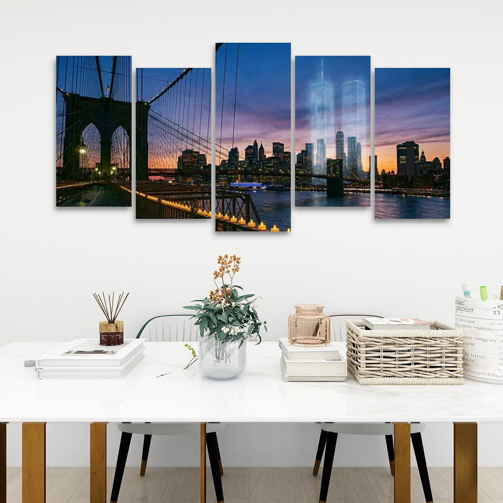 A five-panel canvas wall art set depicting a Brooklyn city skyline at dusk, hung above a white dining table with books, a vase, and baskets in a modern room setting.
